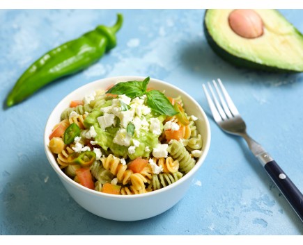 Vegetable fusilli with avocado cream, tomatoes, basil and feta cheese