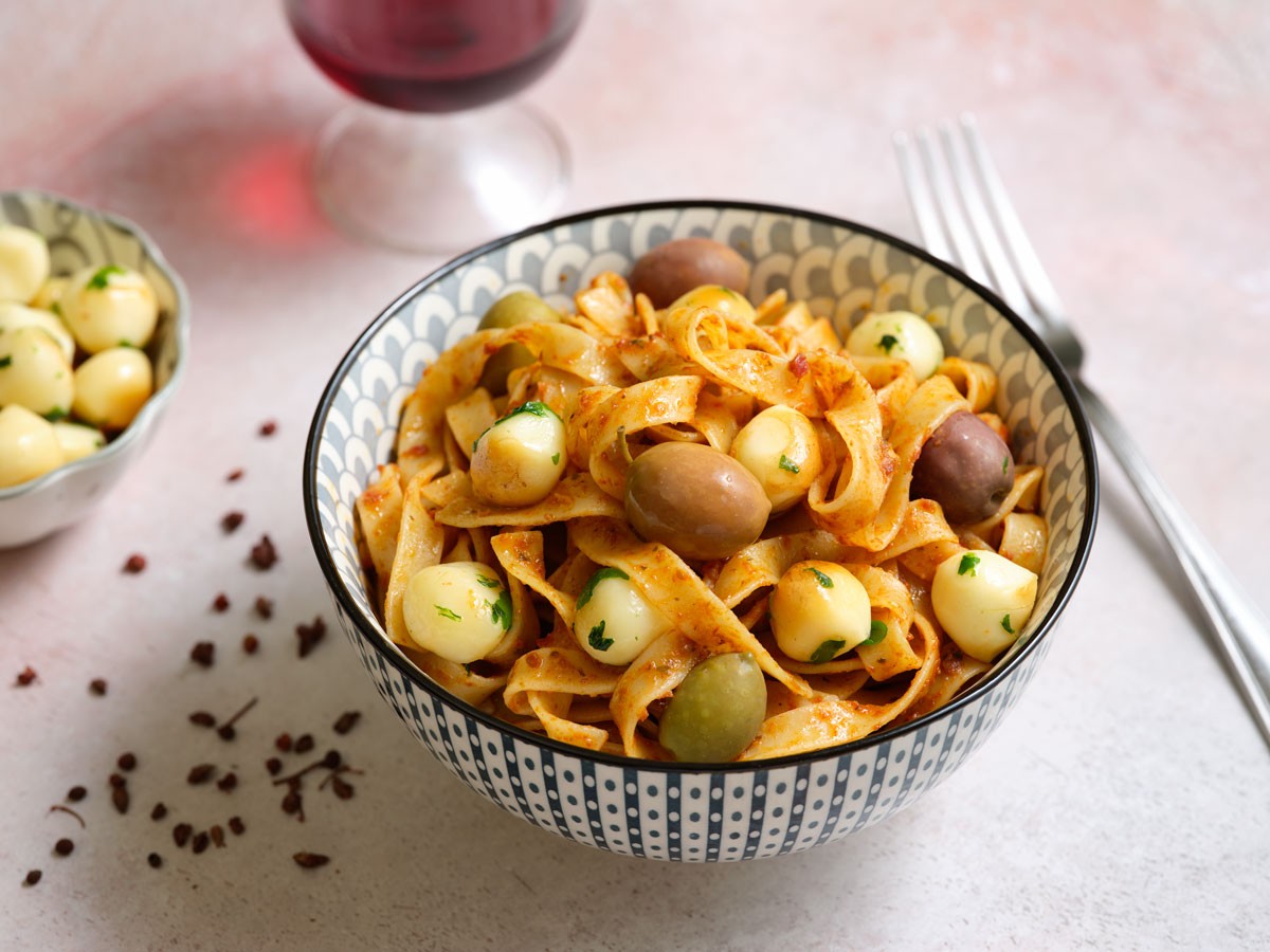 Tagliatelle with tomato pesto, smoked provola cheese and black olives